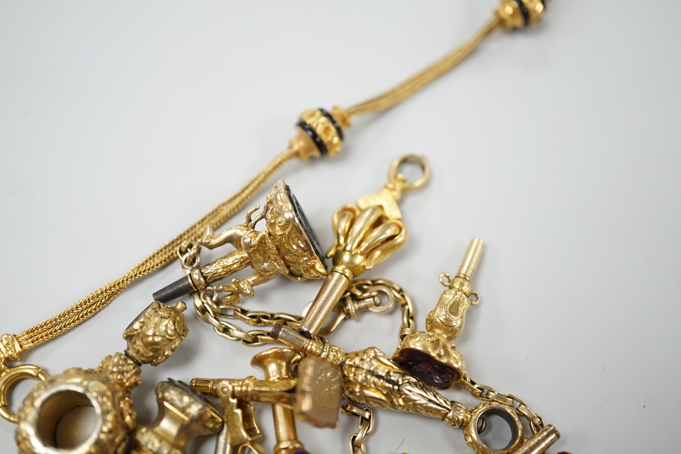A small collection of fifteen assorted mainly 19th century yellow metal or gold plated watch keys including, one rose cut diamond set, one enamelled locket, six gem stone set, one enamelled, one surmounted with deer and